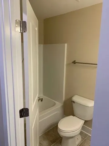 a white toilet sitting next to a bathroom sink
