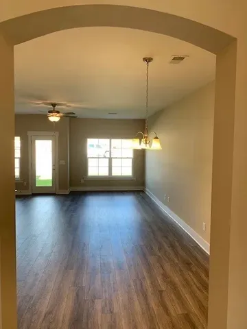 a view of a room with window and wooden floor