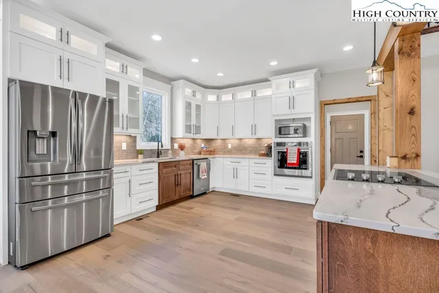 a kitchen with stainless steel appliances sink refrigerator and microwave