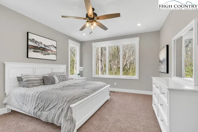 a bedroom with a large bed and a window