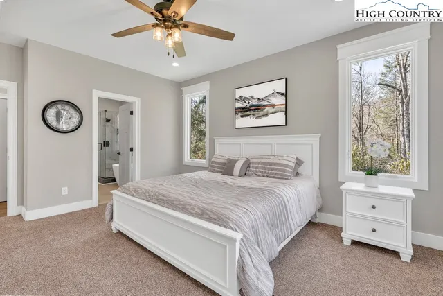 a spacious bedroom with a bed and a chandelier