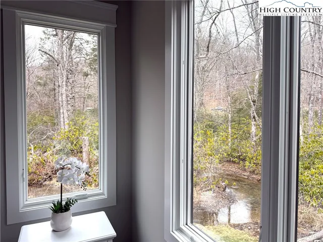 a view of a room that has a bed and wooden floor