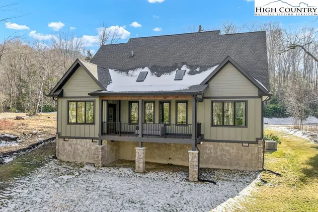 a view of a house with a yard and pathway