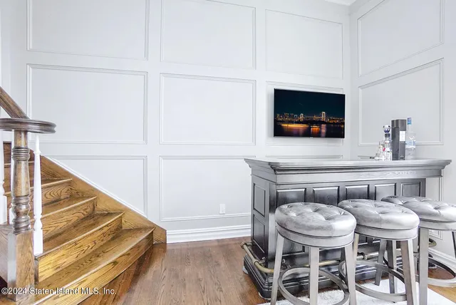 a dining room with furniture and wooden floor