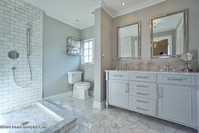 a bathroom with a granite countertop sink a toilet and a mirror