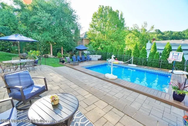 a view of a chairs and table in the patio with a fire pit