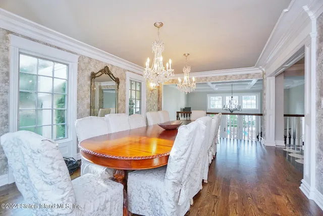 a dining room with furniture and wooden floor