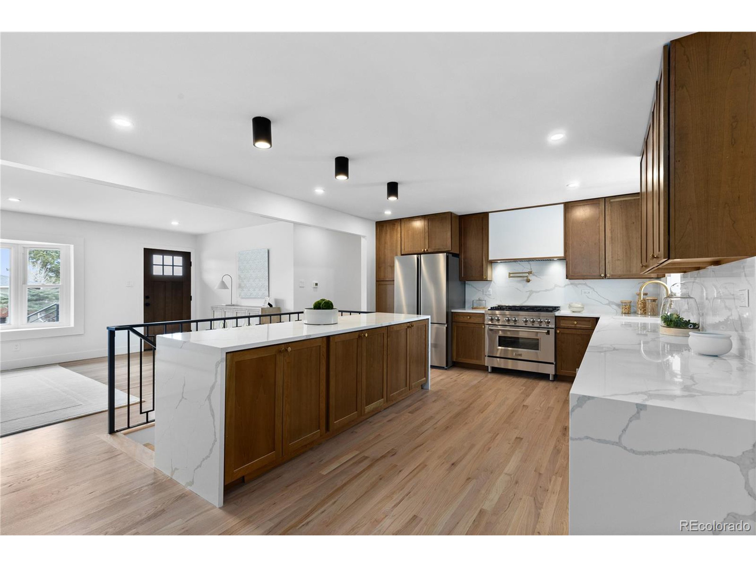 a kitchen with stainless steel appliances kitchen island wooden cabinets and granite counter tops