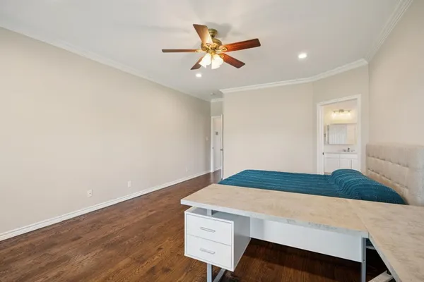 a bedroom with a bed and a ceiling fan