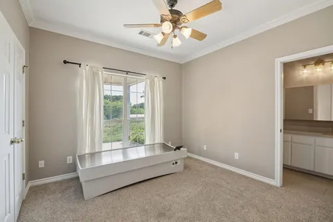 a spacious bedroom with a bed and a chandelier