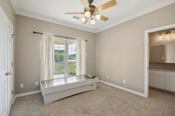 a spacious bedroom with a bed and a chandelier
