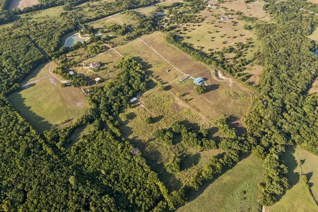 an aerial view of residential house with pool and garden