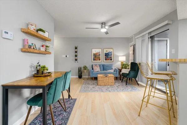 a living room with furniture and a wooden floor