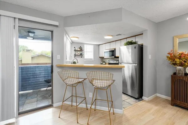 a kitchen with stainless steel appliances a refrigerator and a stove top oven