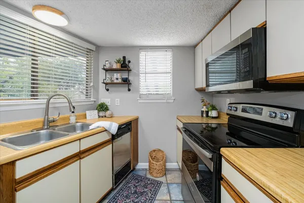 a kitchen with a sink appliances and cabinets