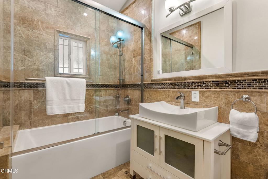 1544 La Loma Road Pasadena, CA 91105 - Photo 19 of 28 a bathroom with a sink a vanity a mirror and a bathtub