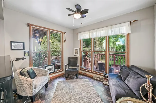 a living room with furniture and a floor to ceiling window