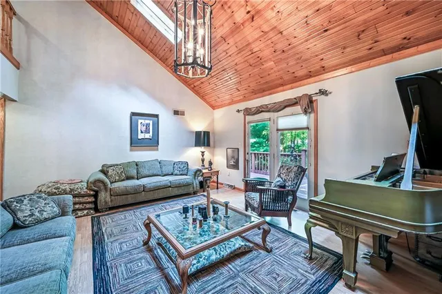 a living room with furniture a table and a large window