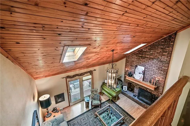 a spacious bathroom with a tub shower and window