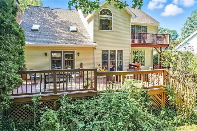 a view of deck with furniture and trees