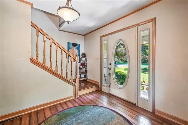 a view of an entryway with wooden floor