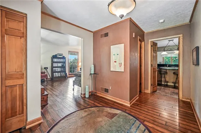 a view of a hallway view with wooden floor and living room