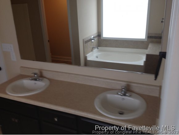 232 Decatur Drive Fayetteville, NC 28303 - Photo 14 of 25 a bathroom with a sink and a mirror