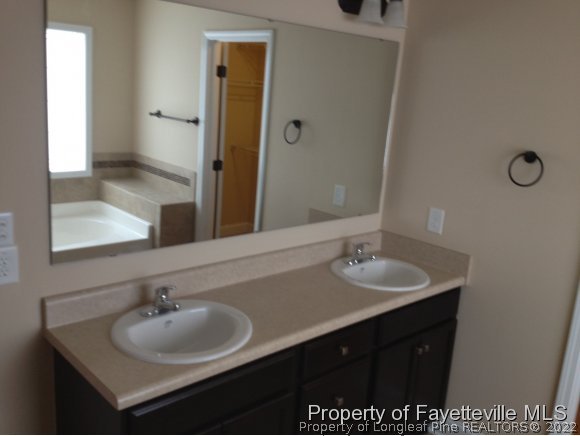 232 Decatur Drive Fayetteville, NC 28303 - Photo 15 of 25 a bathroom with a sink and a mirror
