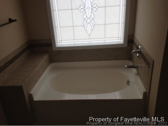 232 Decatur Drive Fayetteville, NC 28303 - Photo 16 of 25 a bath tub sitting in a bathroom next to a window