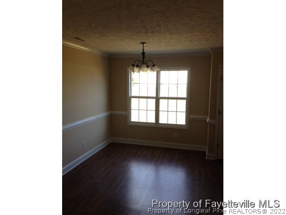 232 Decatur Drive Fayetteville, NC 28303 - Photo 23 of 25 a view of an empty room with wooden floor and a window