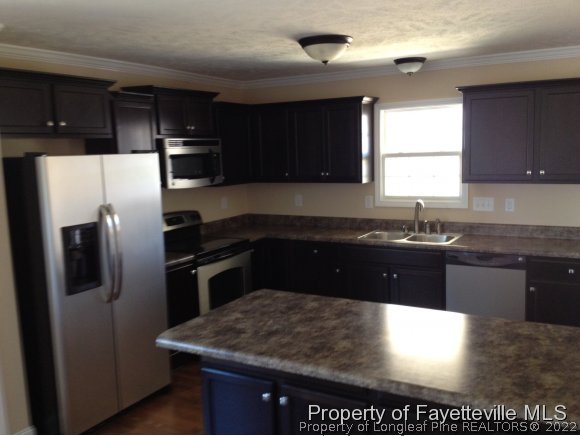 232 Decatur Drive Fayetteville, NC 28303 - Photo 25 of 25 a kitchen with a sink and a refrigerator