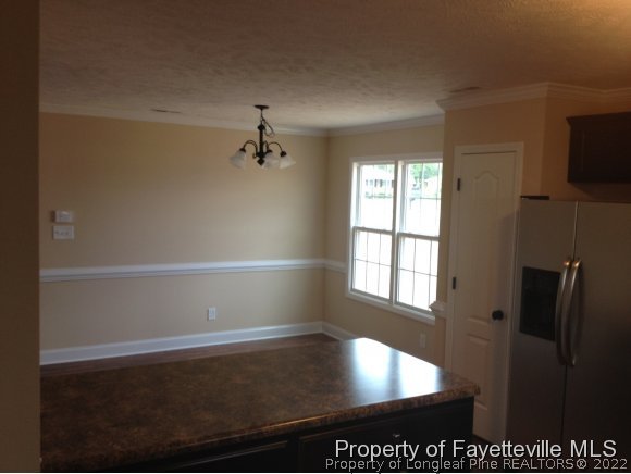 232 Decatur Drive Fayetteville, NC 28303 - Photo 7 of 25 a view of empty room with wooden floor and fan