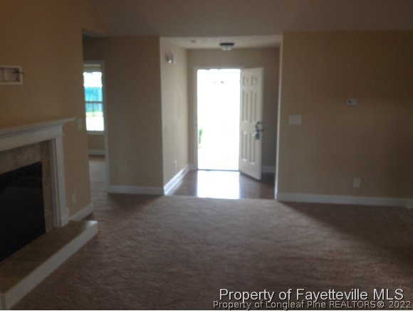232 Decatur Drive Fayetteville, NC 28303 - Photo 9 of 25 a view of an empty room with a fireplace and a window