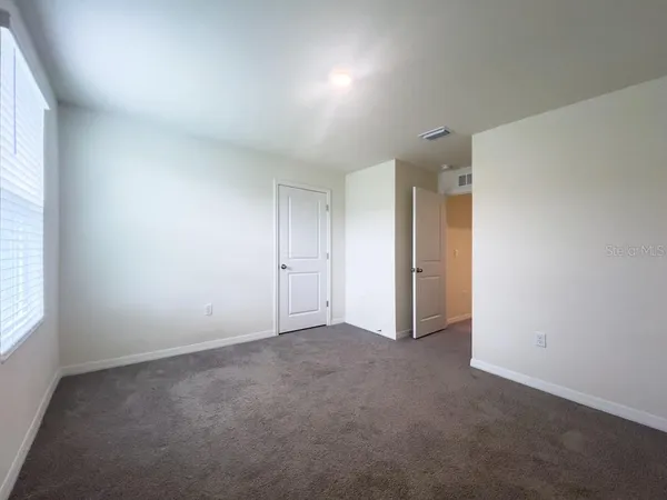 a bathroom with a double vanity sink a toilet and a bathtub
