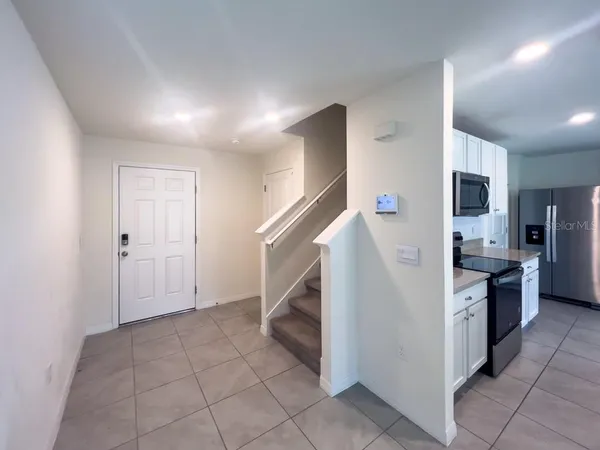 a kitchen with granite countertop a refrigerator and a stove