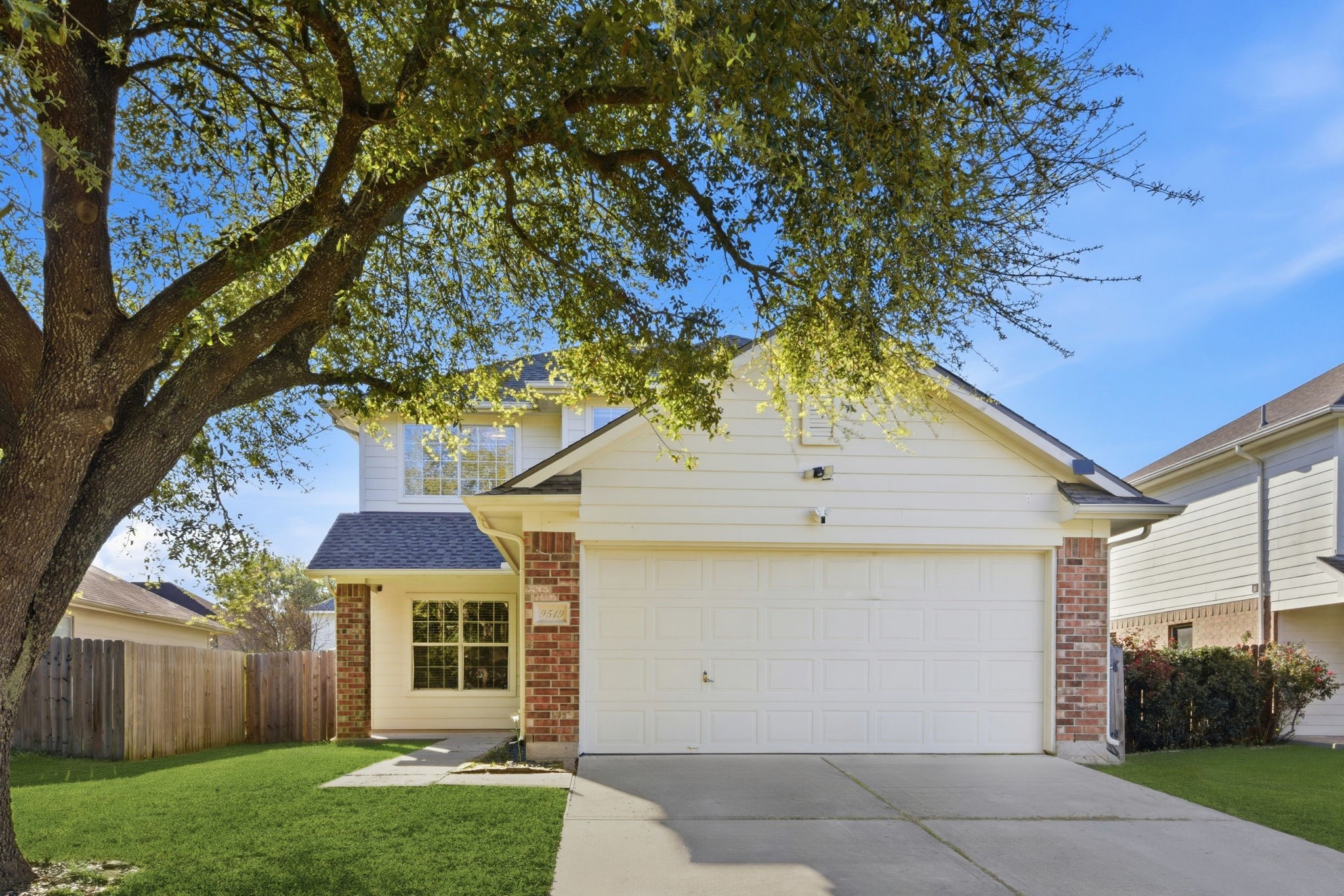 9519 Maple Green Lane Houston, TX 77044 - Photo 1 of 50 a front view of a house with a yard and garage
