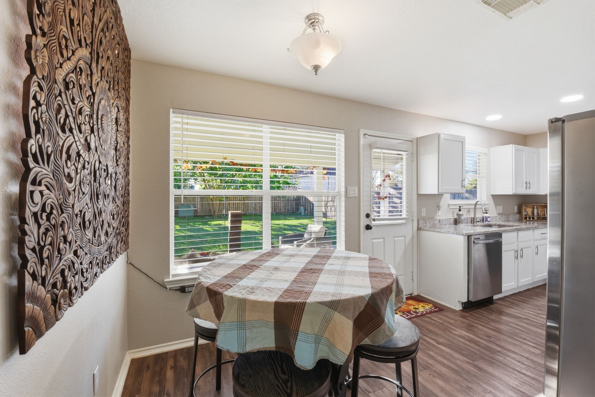 9519 Maple Green Lane Houston, TX 77044 - Photo 12 of 50 a kitchen with a table chairs and wooden floor