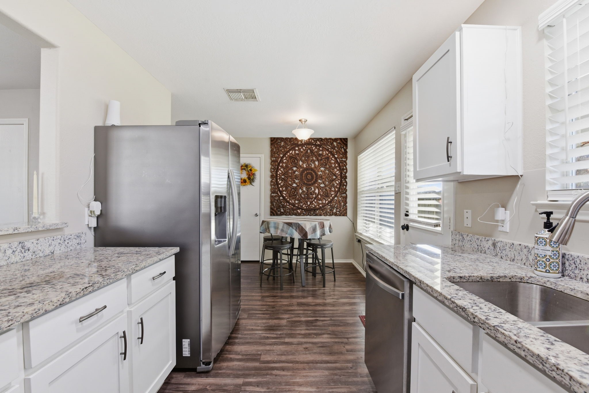 9519 Maple Green Lane Houston, TX 77044 - Photo 15 of 50 a kitchen with granite countertop a sink cabinets stainless steel appliances and a window