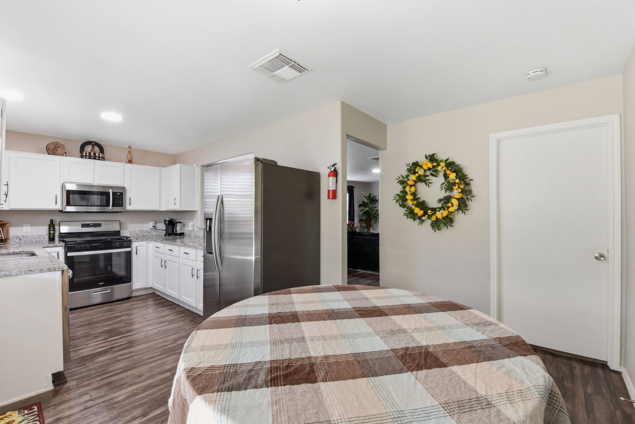 9519 Maple Green Lane Houston, TX 77044 - Photo 35 of 50 a kitchen with a refrigerator and a stove top oven