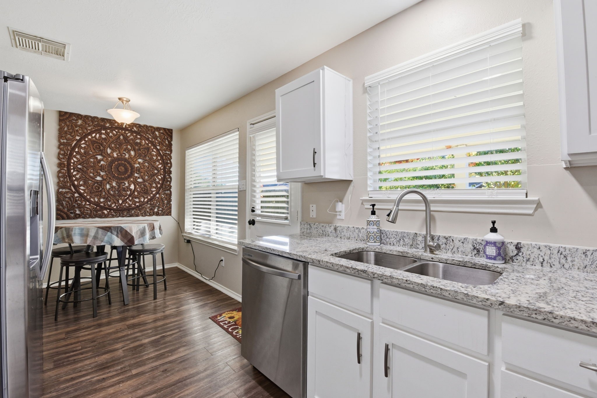 9519 Maple Green Lane Houston, TX 77044 - Photo 45 of 50 a kitchen with sink cabinets and wooden floor