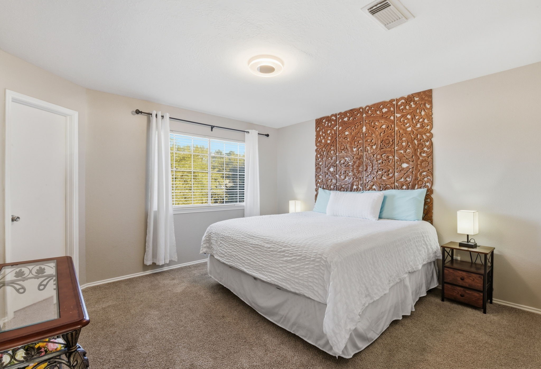 9519 Maple Green Lane Houston, TX 77044 - Photo 46 of 50 a large bed sitting in a bedroom next to a window