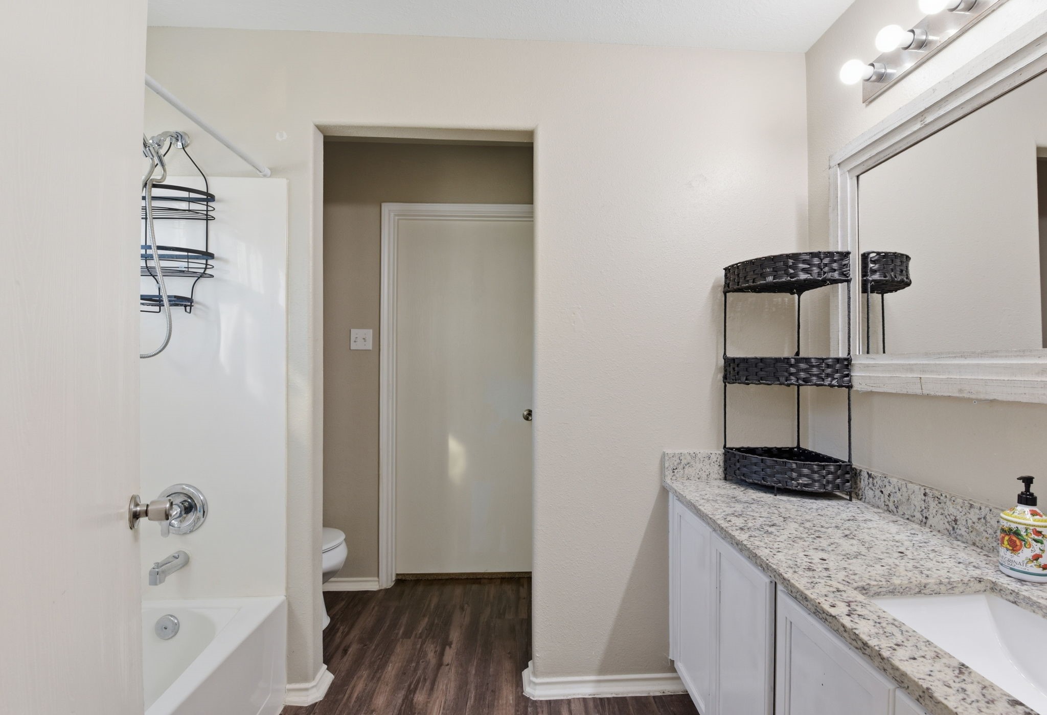 9519 Maple Green Lane Houston, TX 77044 - Photo 47 of 50 a bathroom with a granite countertop sink and a mirror