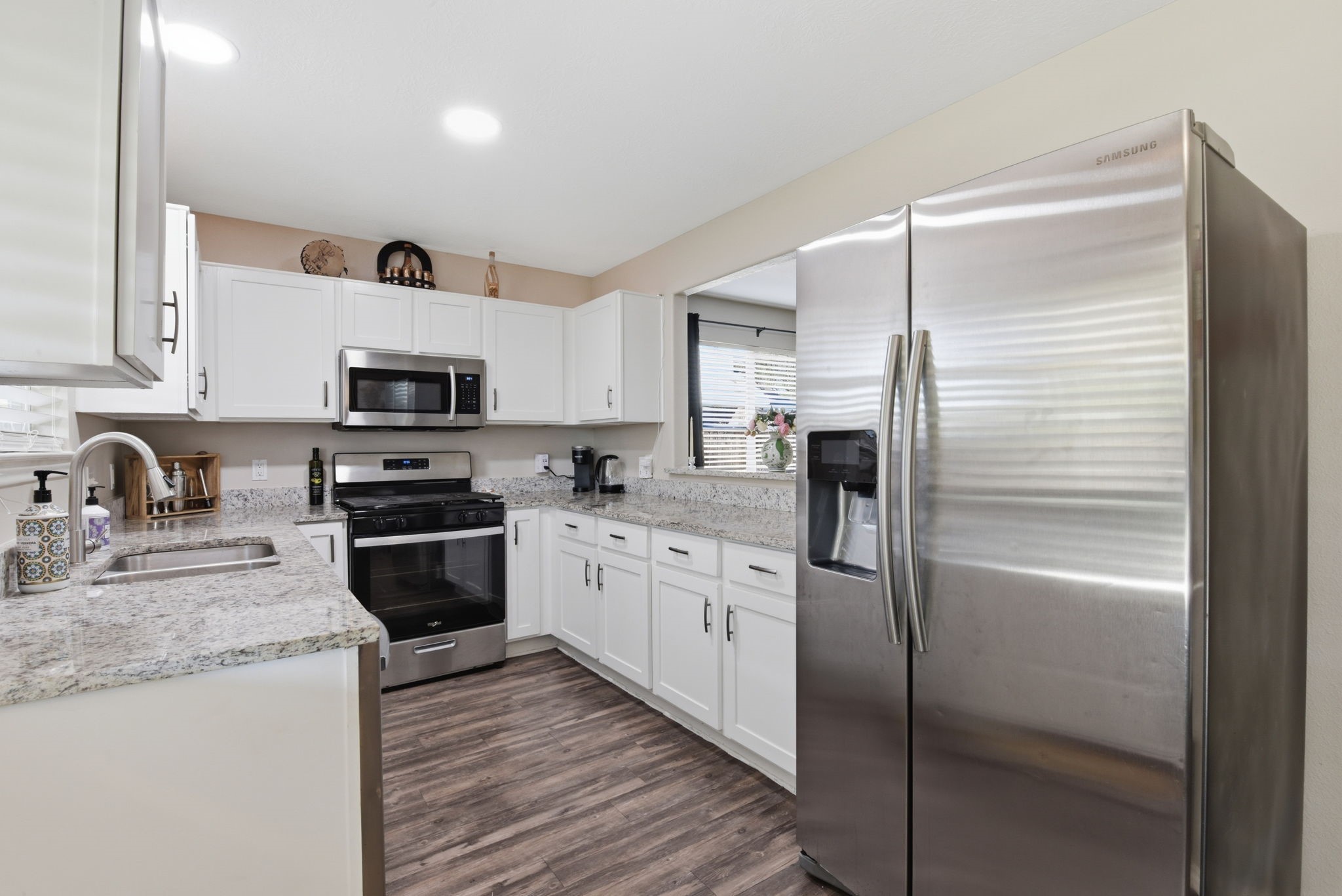 9519 Maple Green Lane Houston, TX 77044 - Photo 50 of 50 a kitchen with granite countertop stainless steel appliances cabinets a sink and a refrigerator
