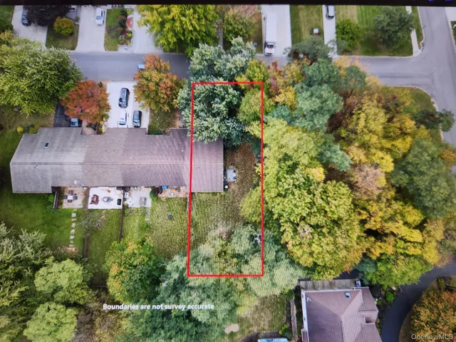 an aerial view of a house with a yard and garden