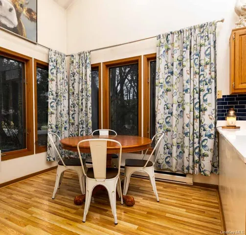 a dining room with furniture and wooden floor