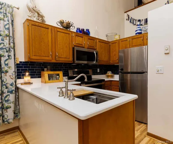 a kitchen with a sink a microwave and cabinets
