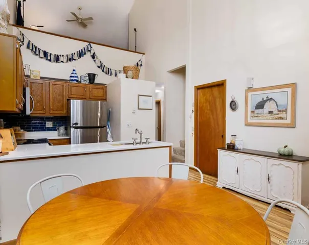 a view of a kitchen with a sink cabinet and refrigerator