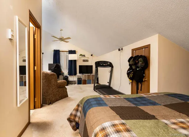 a view of a bedroom with bed and glass door