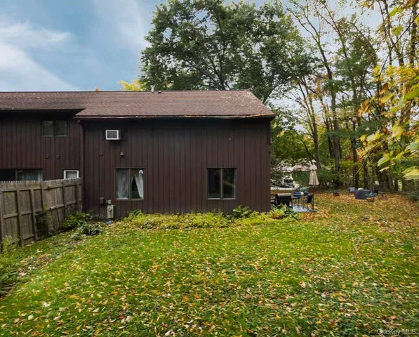 a backyard of a house with table and chairs