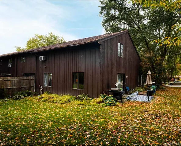 a backyard of a house with table and chairs